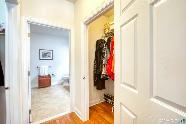 a view of walk in closet with clothes and shoes
