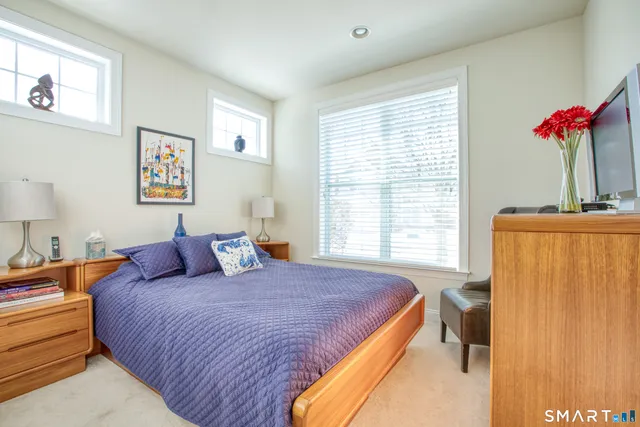 a bedroom with bed and a window