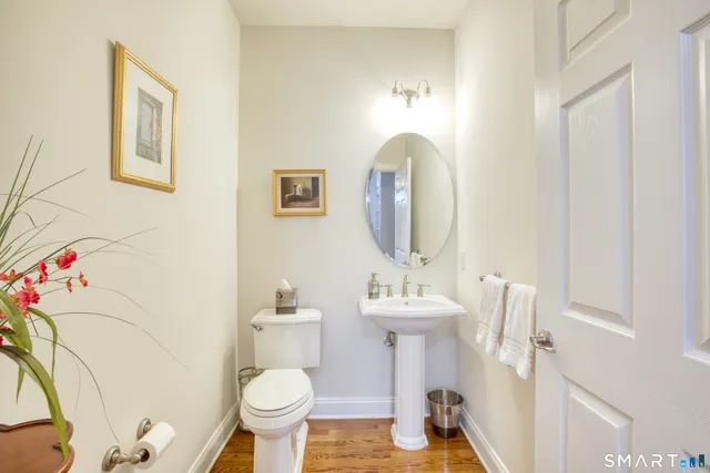 a bathroom with a toilet sink and mirror