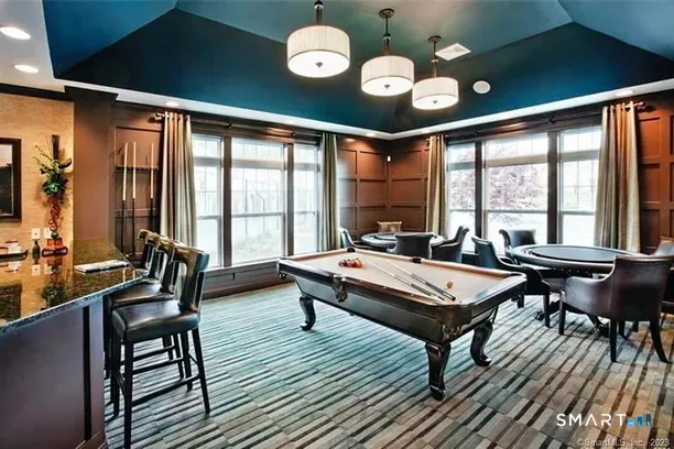 a living room with furniture a rug and a large window