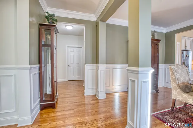 a view of a hallway with wooden floor and staircase