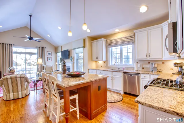 a open kitchen with granite countertop lots of counter top space and dining table