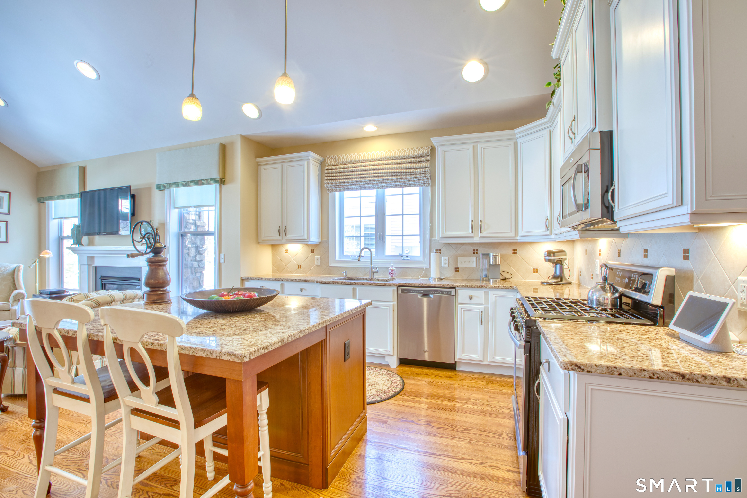 12 Briar Ridge Drive, Unit 12 Bethel, CT 06801 - Photo 9 of 34 a kitchen with granite countertop kitchen island wooden cabinets and refrigerator