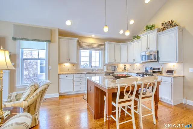 a large kitchen with a table and chairs