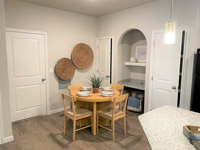 a kitchen with kitchen island a appliances dining table and chairs