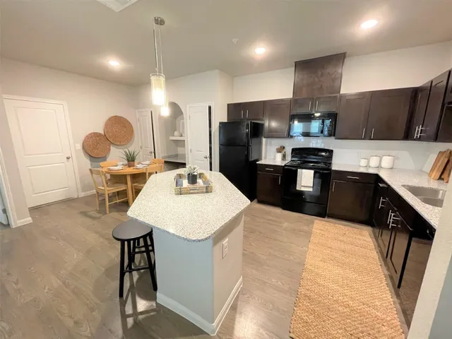 a kitchen with refrigerator and cabinets