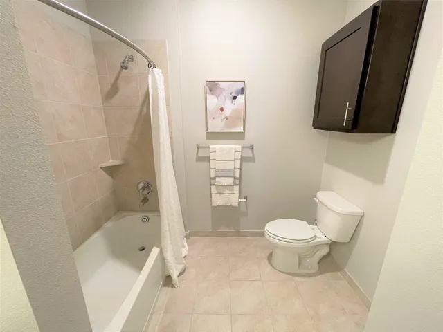 a en suite bathroom with a granite countertop sink and a mirror
