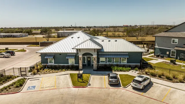 an aerial view of a house with swimming pool and patio