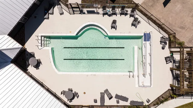 a view of a house with pool and chairs