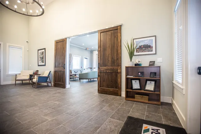 a living room with furniture and a chandelier