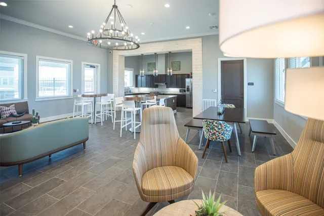 a kitchen with stainless steel appliances granite countertop a stove a sink a dining table and chairs