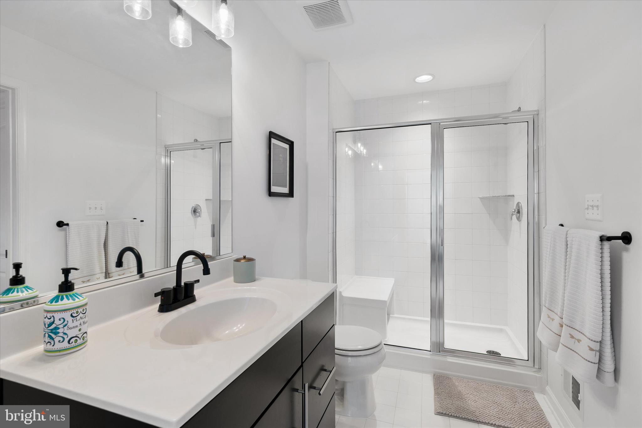 36114 Watch Hill Road Frankford, DE 19945 - Photo 32 of 80 a bathroom with a sink a toilet and shower