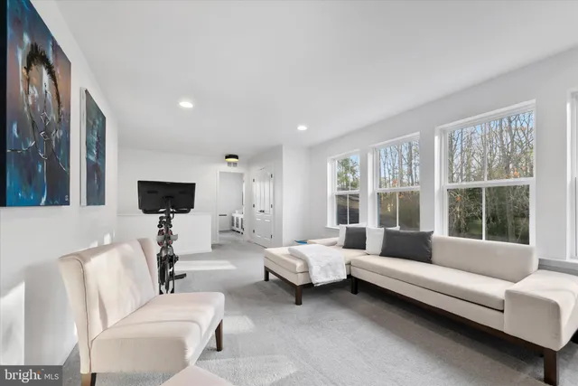 a living room with furniture a window and a table