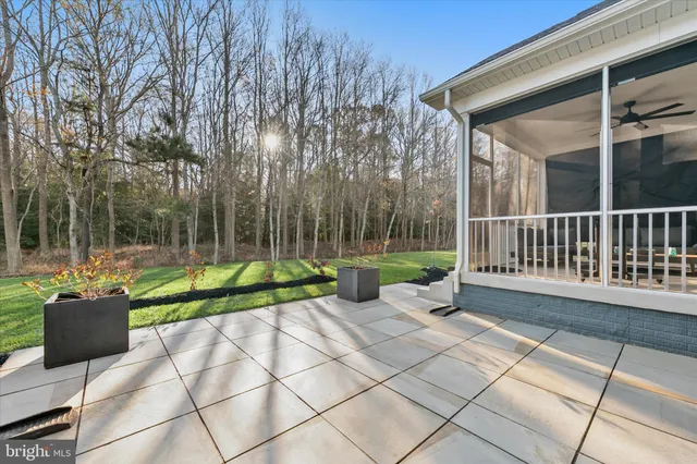 a view of a patio with a table and chairs under an umbrella