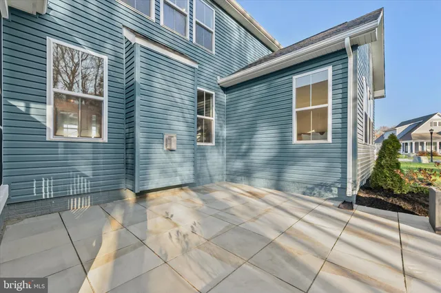 a view of a patio with dining table and chairs with wooden floor