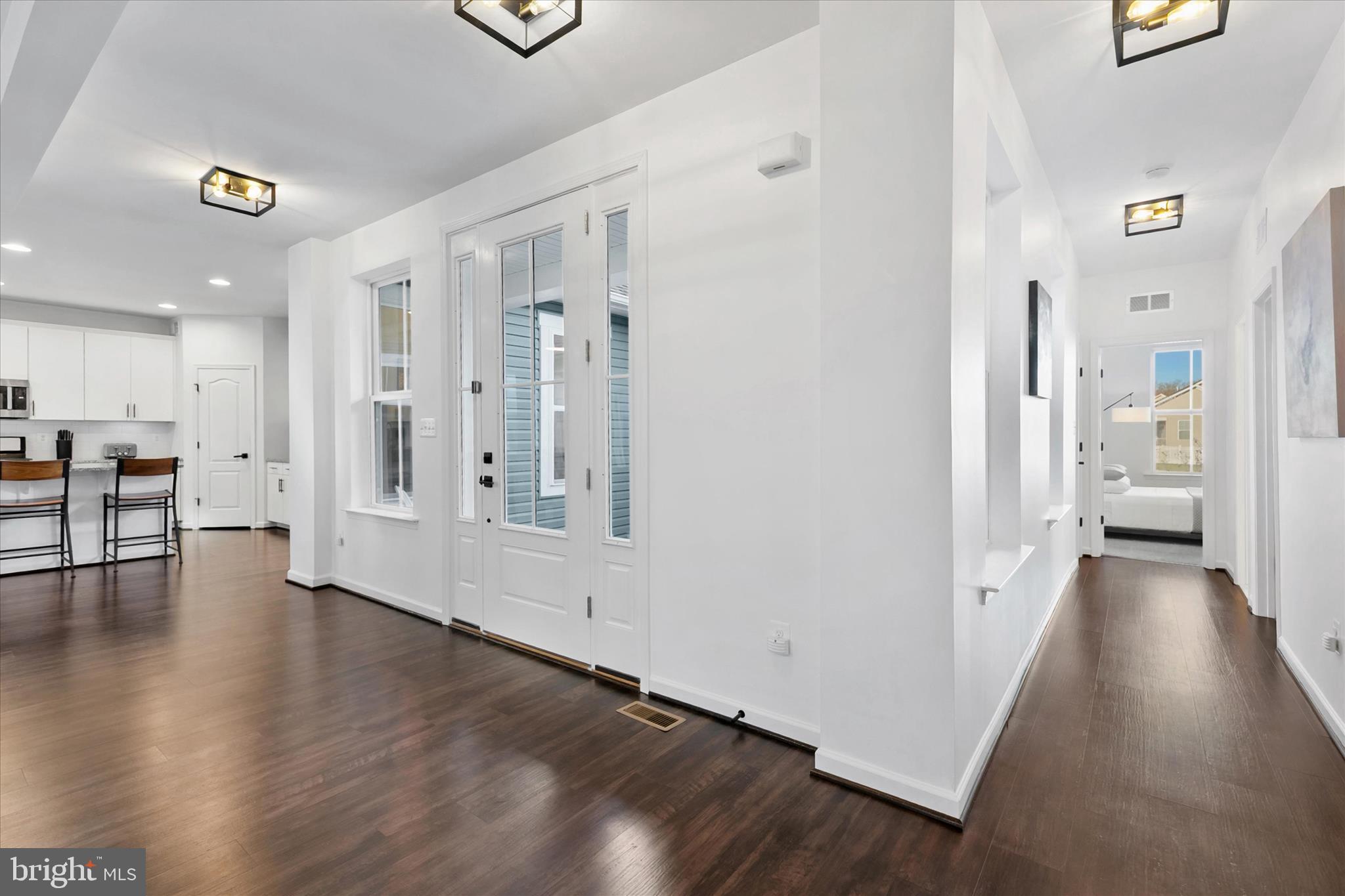 36114 Watch Hill Road Frankford, DE 19945 - Photo 45 of 80 a view of a hallway with wooden floor windows and a livingroom