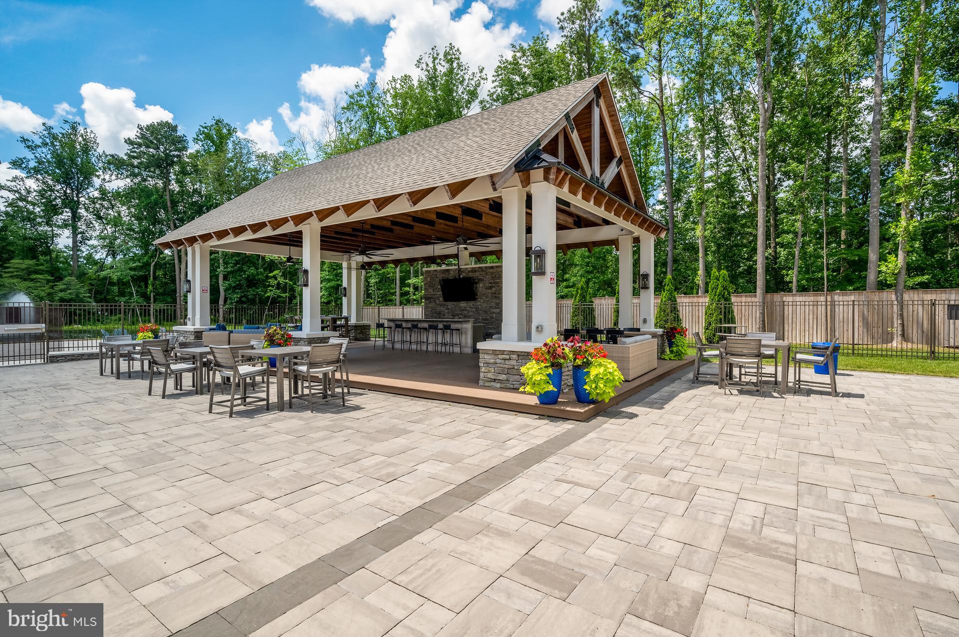 36114 Watch Hill Road Frankford, DE 19945 - Photo 66 of 80 a view of a patio with a table and chairs under an umbrella