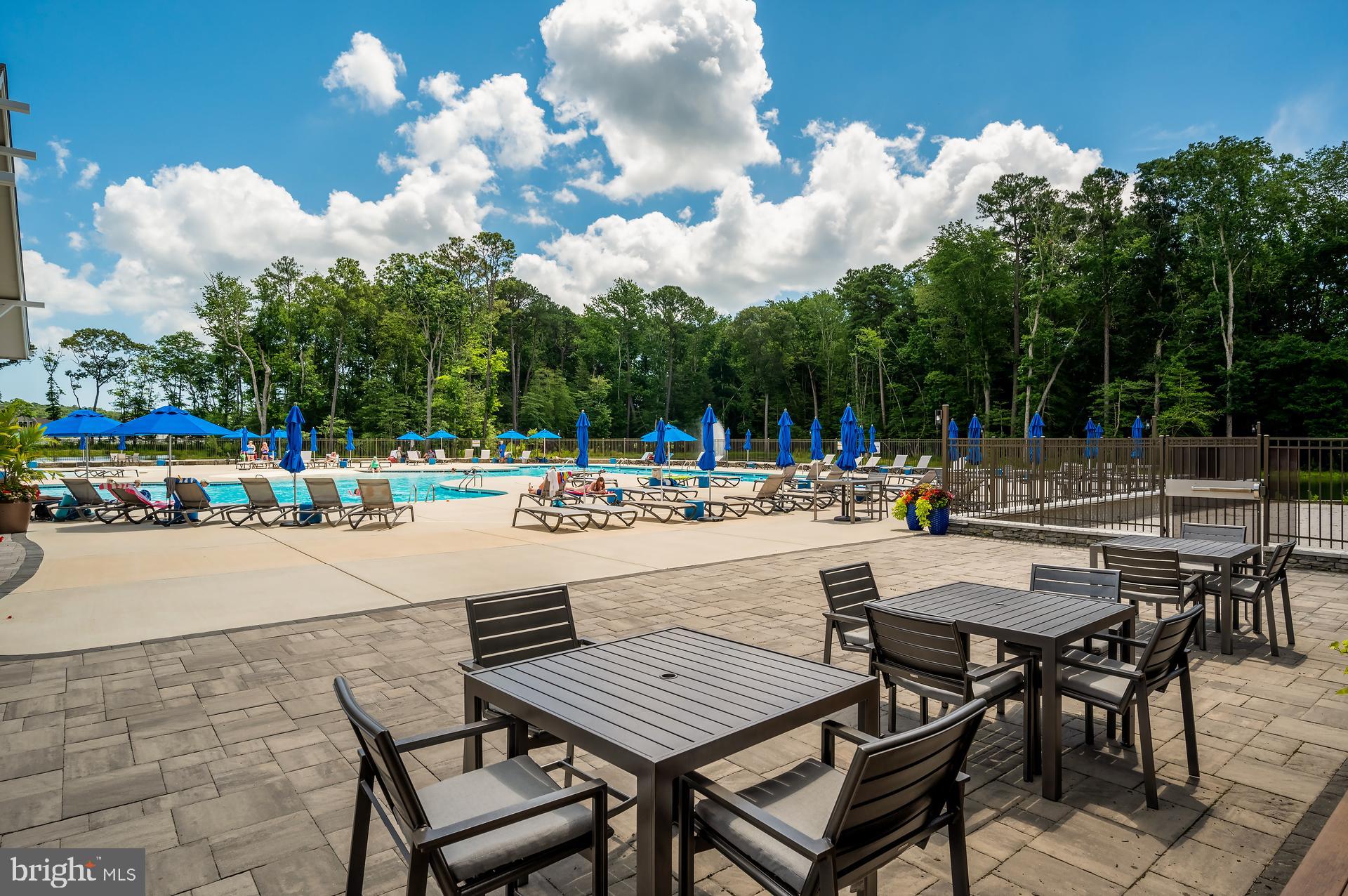 36114 Watch Hill Road Frankford, DE 19945 - Photo 68 of 80 a view of a patio with dining table and chairs with wooden floor
