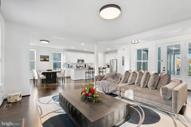 a kitchen with white cabinets and sink