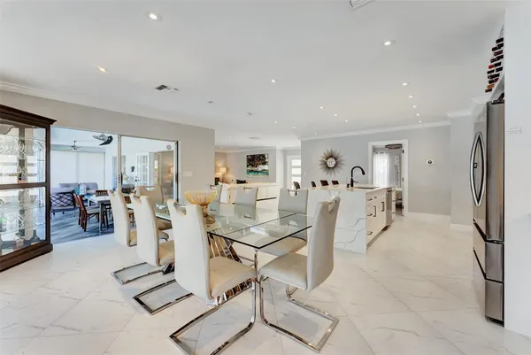 a dining room with furniture a chandelier and wooden floor