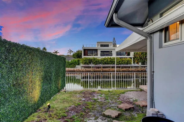 an aerial view of a house with a swimming pool and outdoor seating
