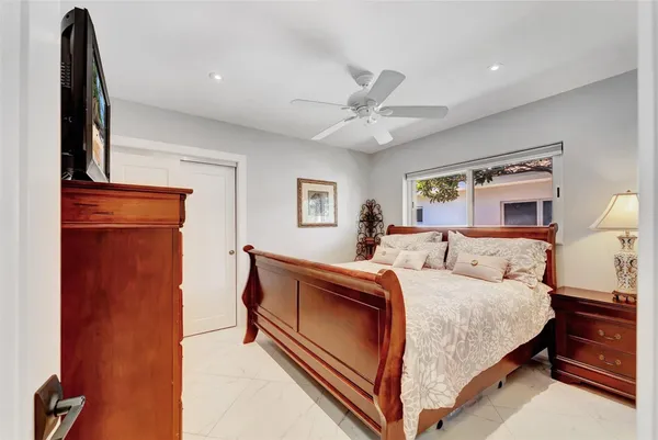 a bedroom with a large bed and a chandelier