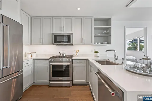 a kitchen with a sink stove and refrigerator
