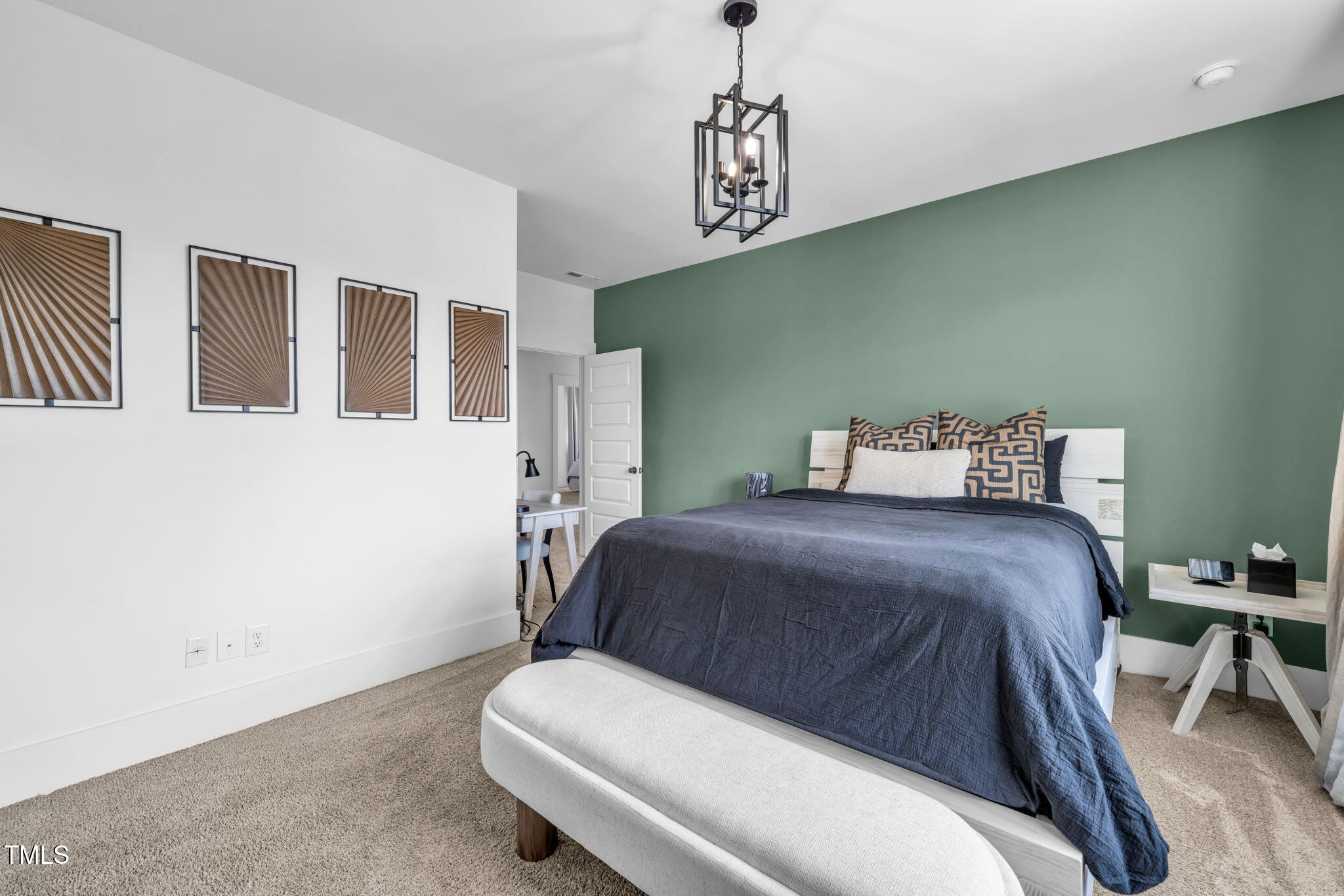 325 Liberty Star Road Wendell, NC 27591 - Photo 50 of 83 a bedroom with a bed and a chandelier