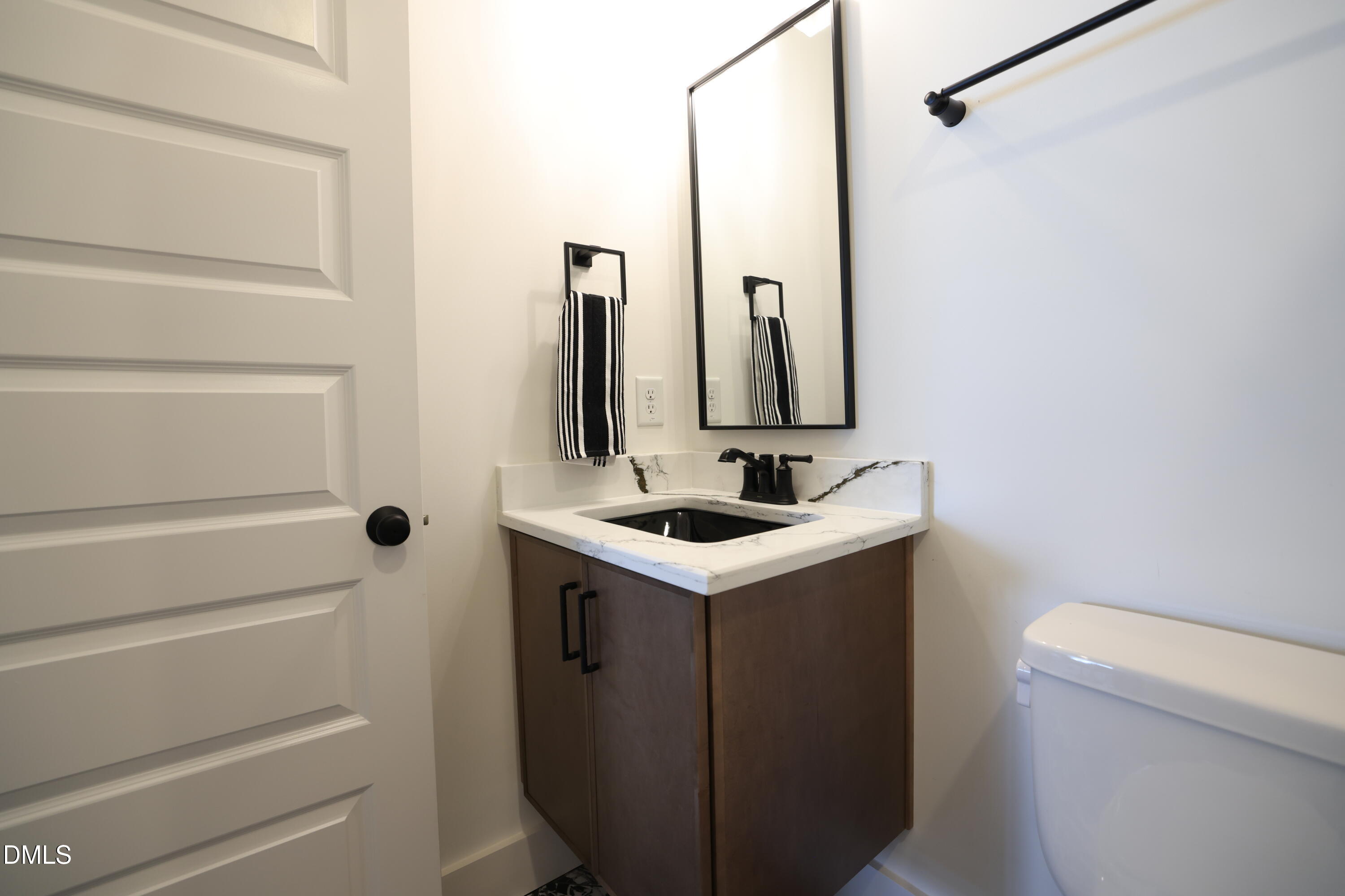 325 Liberty Star Road Wendell, NC 27591 - Photo 59 of 83 a bathroom with a sink and mirror with toilet
