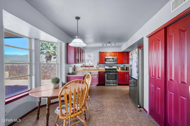 a kitchen with stainless steel appliances granite countertop a sink dishwasher stove and refrigerator