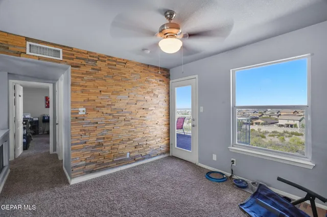 a view of a livingroom with a ceiling fan and window