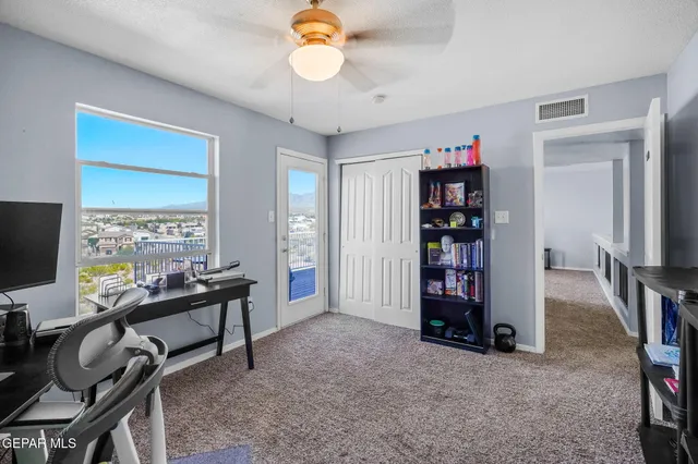 a living room with furniture fireplace and a large window