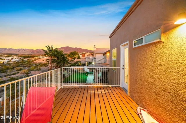 a view of a balcony with wooden floor
