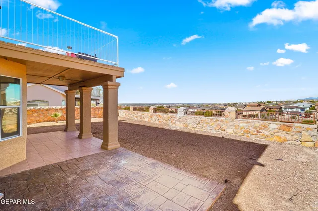a view of a roof deck with chair and wooden floor