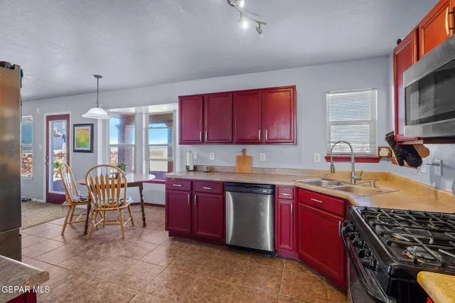 a dining room with furniture a chandelier and window