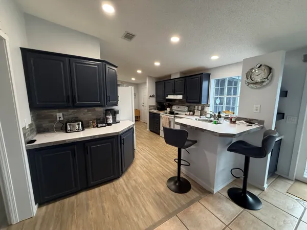 a white toilet sitting next to a bathroom sink