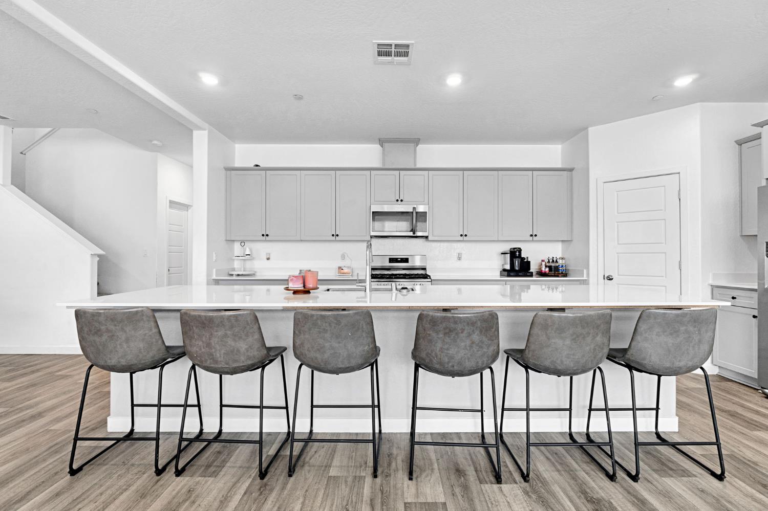 2831 North Redda Road Fresno, CA 93737 - Photo 11 of 41 a kitchen with a dining table chairs and wooden floor