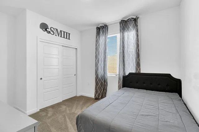 a bedroom with a bed and a dresser