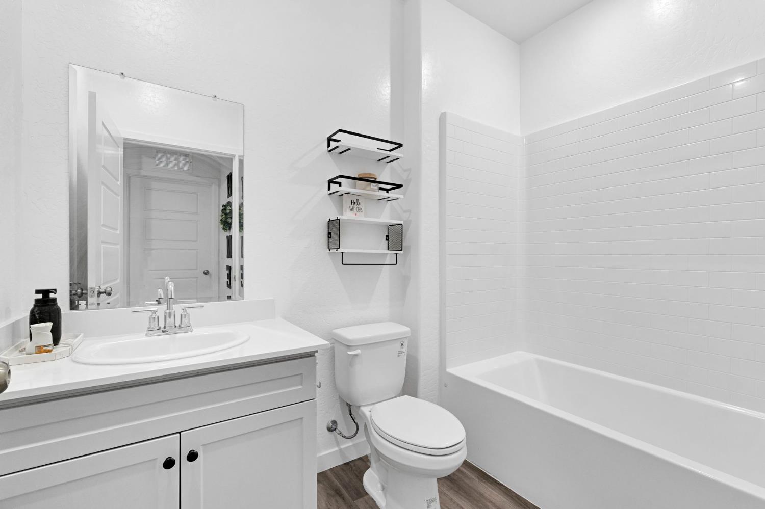 2831 North Redda Road Fresno, CA 93737 - Photo 19 of 41 a bathroom with a sink a toilet and shower