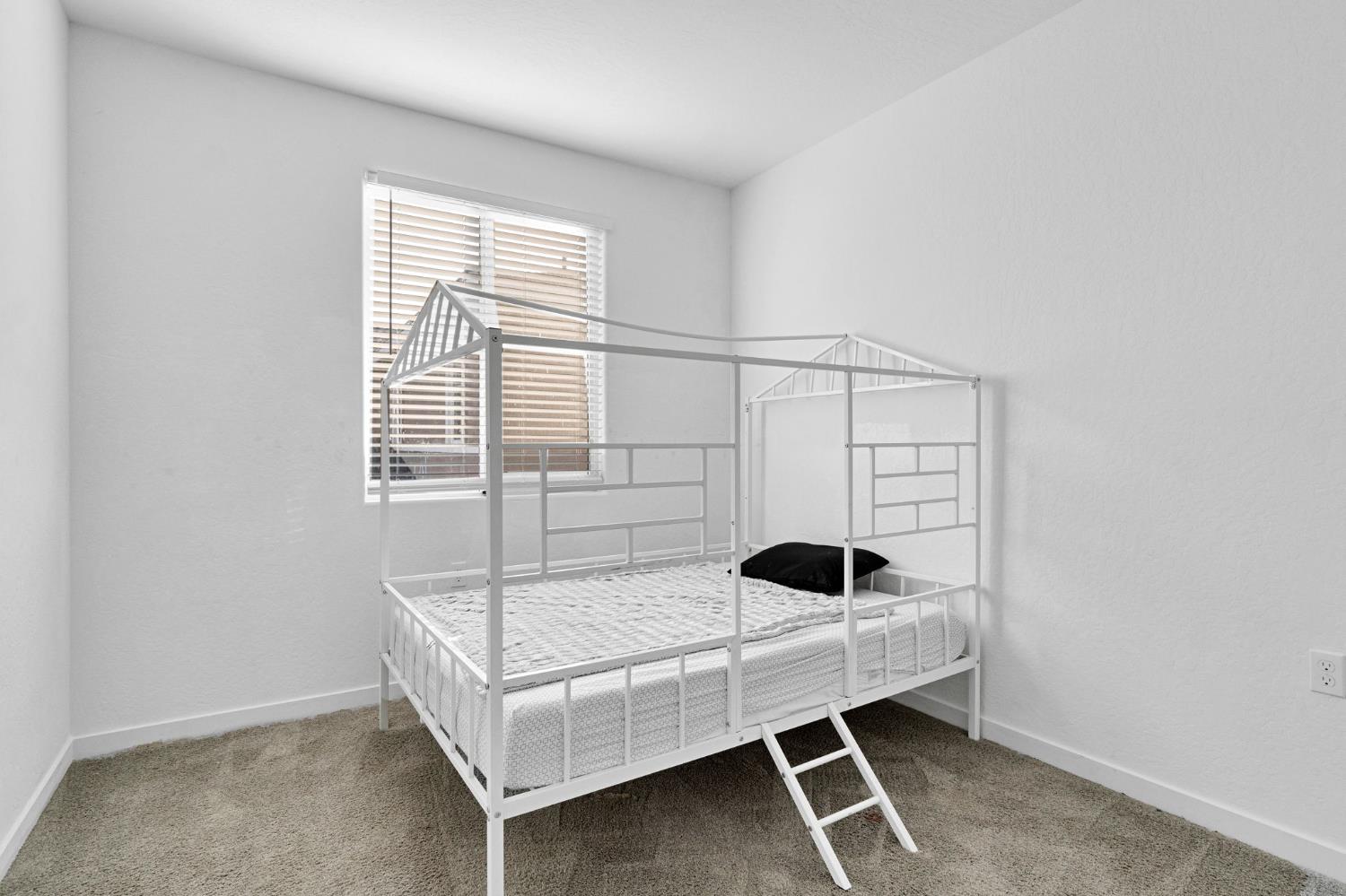 2831 North Redda Road Fresno, CA 93737 - Photo 27 of 41 a bedroom with a bed and a window