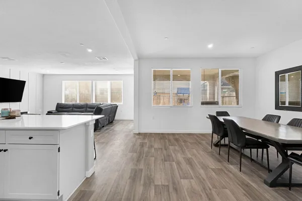 a living room with furniture and view of kitchen