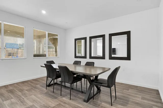 a view of a a dining room with furniture and window