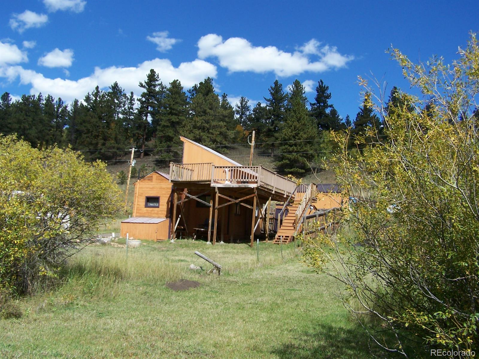 282 Bishop Road Bailey, CO 80421 - Photo 4 of 11 a view of a house with a yard