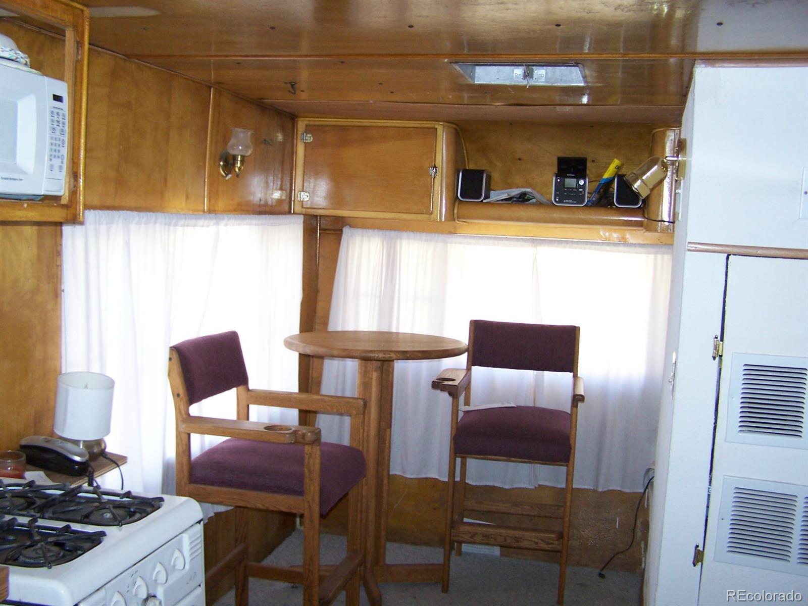 282 Bishop Road Bailey, CO 80421 - Photo 8 of 11 a dining room with furniture and a window