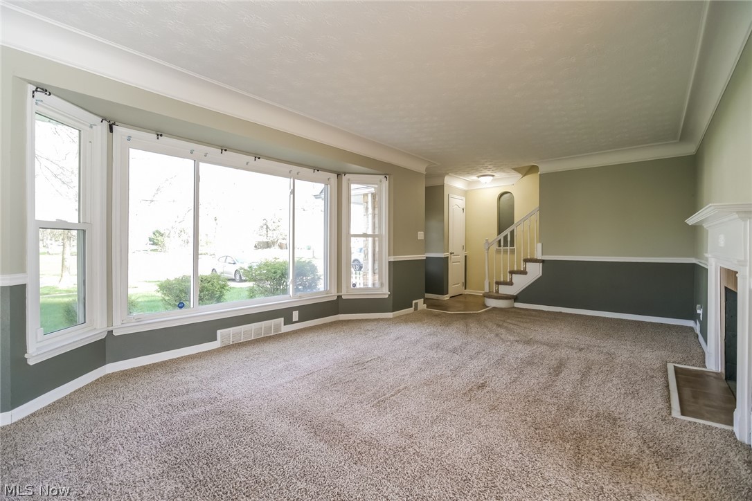 736 Quilliams Road Cleveland Heights, OH 44121 - Photo 10 of 20 Unfurnished living room featuring plenty of natural light and carpet