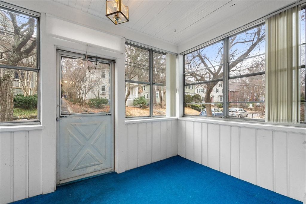 187 Clark Road Brookline, MA 02445 - Photo 11 of 40 a view of an empty room with wooden floor and a window