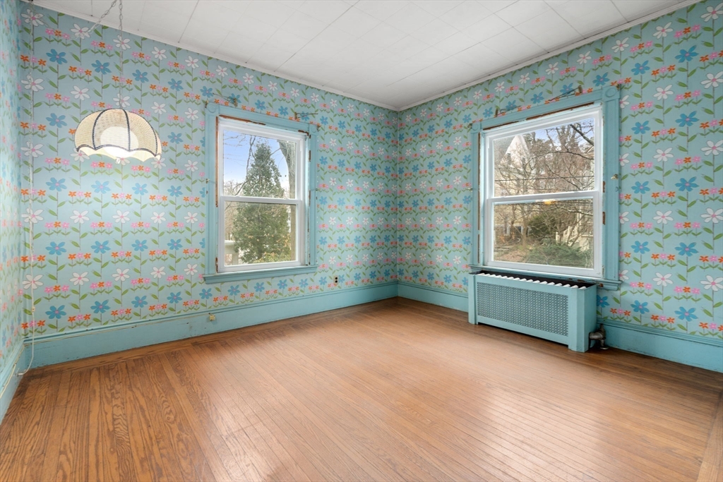 187 Clark Road Brookline, MA 02445 - Photo 19 of 40 wooden floor in an empty room with a window