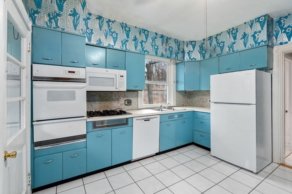 187 Clark Road Brookline, MA 02445 - Photo 20 of 40 a kitchen with a refrigerator and a stove top oven