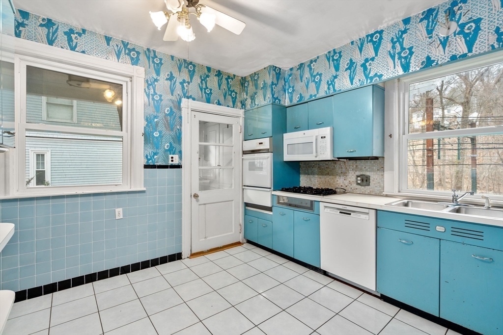 187 Clark Road Brookline, MA 02445 - Photo 26 of 40 a kitchen with a sink cabinets and window