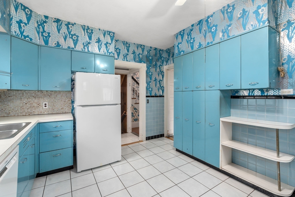 187 Clark Road Brookline, MA 02445 - Photo 27 of 40 a kitchen with a refrigerator and a sink